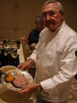 Chef Ted displays their final product...  Prime Rib with a butternut squash puree (with honey and cinnamon, served on steamed spinach and garnished with a homegrown rosemary sprig)... 