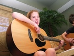 Katelyn screamin' out some Nirvana while she strums the guitar.