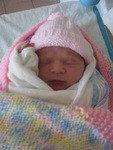 Here's Josie -- all cozied up in her hat, and blankets.. :)