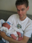 You are witnessing the first time Dan has held a 1 day old baby!  His new name is "Dan the Manny" (Manny = Male Nanny)...  ;)