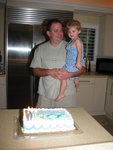 Paige gets ready to help dad blow out the candles.