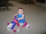 It's almost the new year, and I'm on sister Paige's big wheel!  (Pretty advanced for a 7 1/2 month old!) 