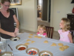 Paige & Josie watch as Mel prepares the different color frostings!