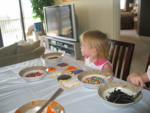 Josie decides what sprinkles she wants to put on the cookies...