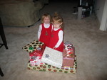 Wow!  More gifts?!  Paige & Josie are dressed in their Christmas jumpers - and ready to open their gifts from Daddy at the Condo!