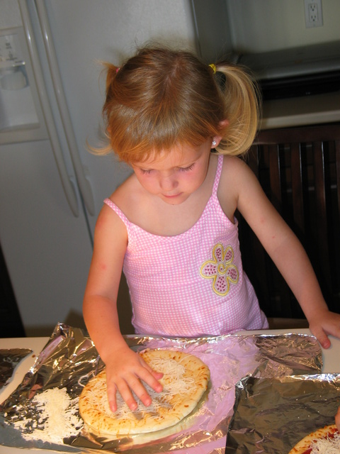 We started out June by making our very own pizzas!  Here's Josie working on her creation...