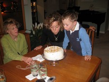 Aw..  Samuel helps Grammi blow out her candles while Mommy Deb watches. 