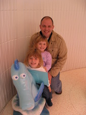 Paige, Josie & Dad ride the Seahorse!  Wheee!