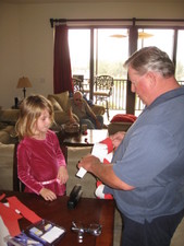 It's time to make the Christmas Chain for the tree!  Here Grandpa Doug shows Paige how its done!