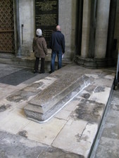 A tomb in the middle of the floor of the Cathedral.