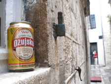 Ozujsko beer can perched in a window while Melanie looks back.

Dubrovnik, Croatia - June 13, 2008