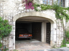 It's amazing that there's room for cars in the skinny road, let alone a garage!