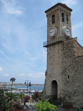 The bell tower of the church with Cannes in the background.