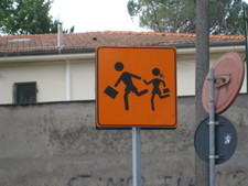 Interesting sign?  Watch out for boys with briefcases pulling girls with purses?