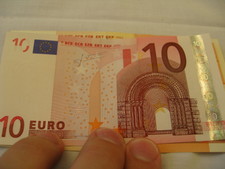 A 10 Euro bill.  Taller than dollars, slimmer than dollars.