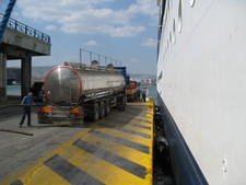 As we returned, I saw this, and wondered how many trucks like that it takes to fill up a ship like this. ;)