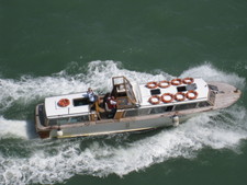 A gal photographs our boat from down below.