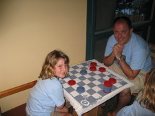 Paige plays her very first game of checkers with daddy!