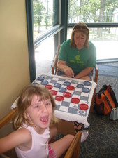 Paige decided she likes checkers, and Amy plays a round with her.