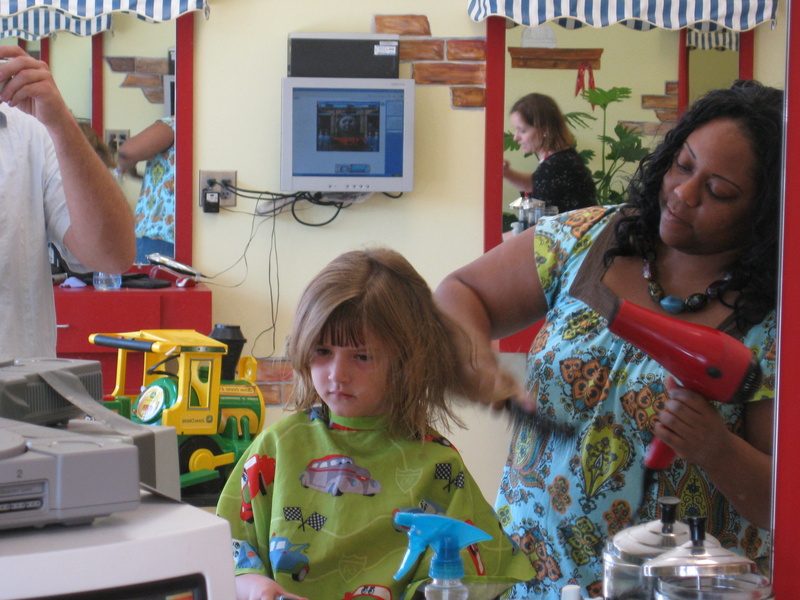 Today we decided to get the girls hair cut and styled!  We went to Kutz for Kids.  

Paige was amazed, she got to play video games (Pac Man) while she got her hair cut!