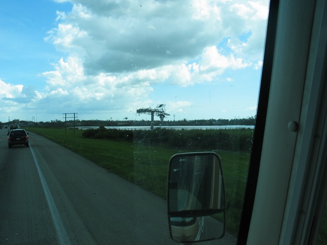 One of the highway billboards completely blown apart, with the structure of a highway sign to the left.