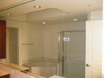 Master Bath - looking into mirror - you can see the bathtub and shower in the distance.