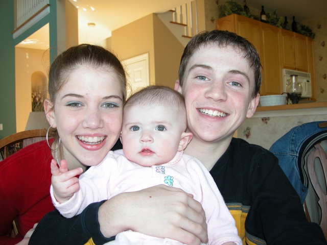 Aunt Kate, Niece Paige, and Uncle Adam pose for you.