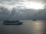 A cool view of the clouds and other cruise ships in port.